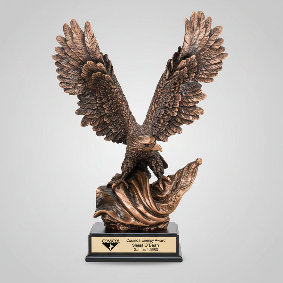 Bronze eagle sculpture on a stump with mountainous landscape in the background